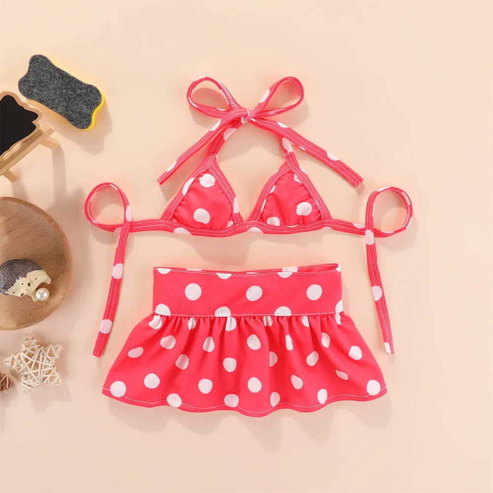 Pink polka dot summer pet swimsuit for dogs and cats displayed on a light background