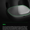 A close-up view of a black smart cat toilet with a glowing green light, showing the litter mat area.