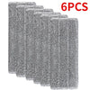 Six reusable gray microfiber mop pads stacked together.