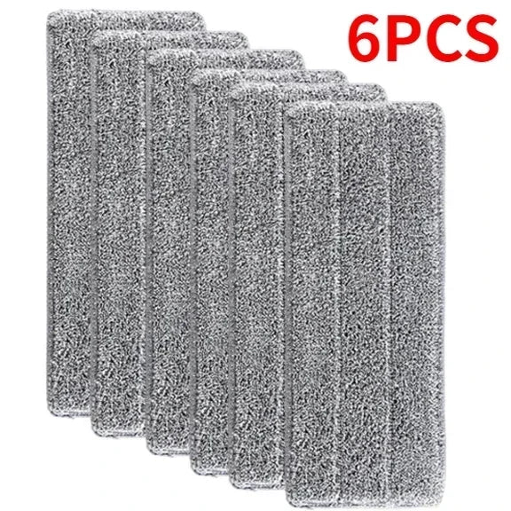 Six reusable gray microfiber mop pads stacked together.
