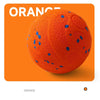 An orange indestructible smart dog chew ball with blue dots shown against an orange background.