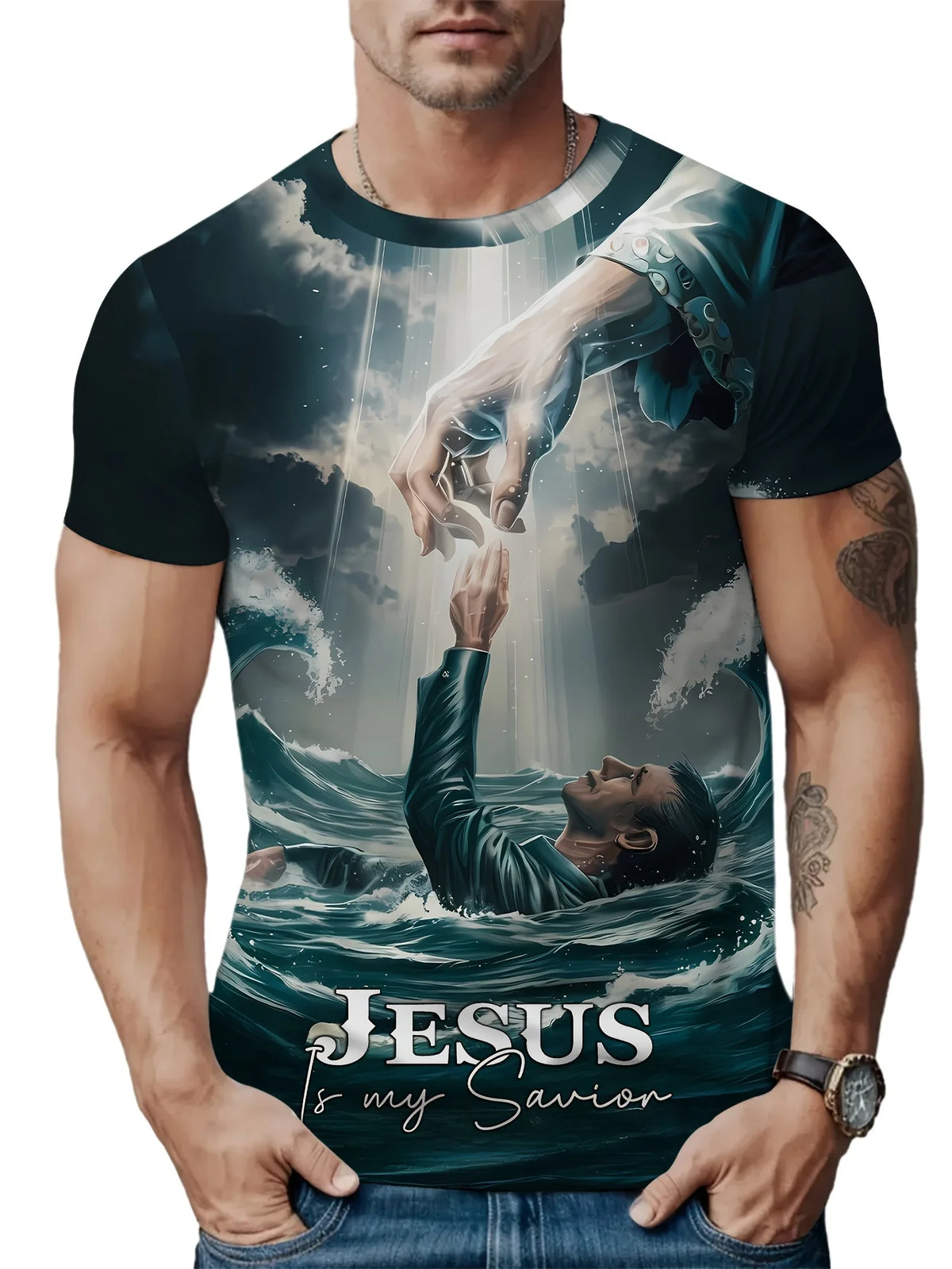 A man wearing a dark t-shirt with a graphic print depicting Jesus and his Savior reaching out to him above crashing waves.
