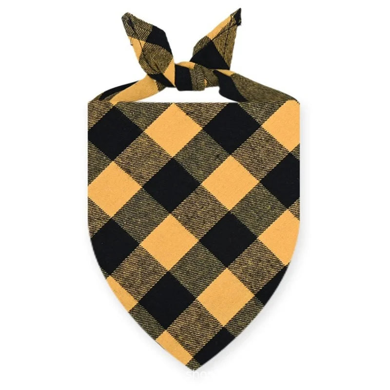 A black and gold plaid bandana tied in a bow for a dog