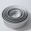 A set of round aluminum cake pans stacked in a circular pattern.