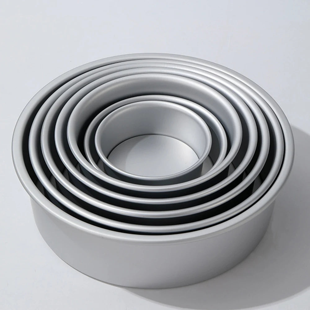 A set of round aluminum cake pans stacked in a circular pattern.
