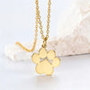 A gold-colored stainless steel cat paw pendant necklace displayed on a white surface.