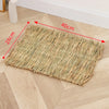 A rectangular mat woven from natural straw placed on a light wooden floor.