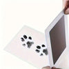 A clear plastic kit containing pet paw prints is being held by a hand.