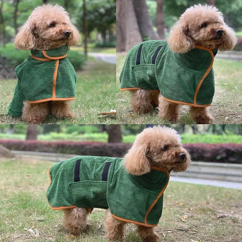 Un chien brun clair et duveteux portant un manteau de serviette vert foncé avec des bordures orange.