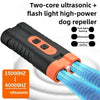 A black ultrasonic dog repeller device with dual flashing lights and a large orange tip is shown against a white background.