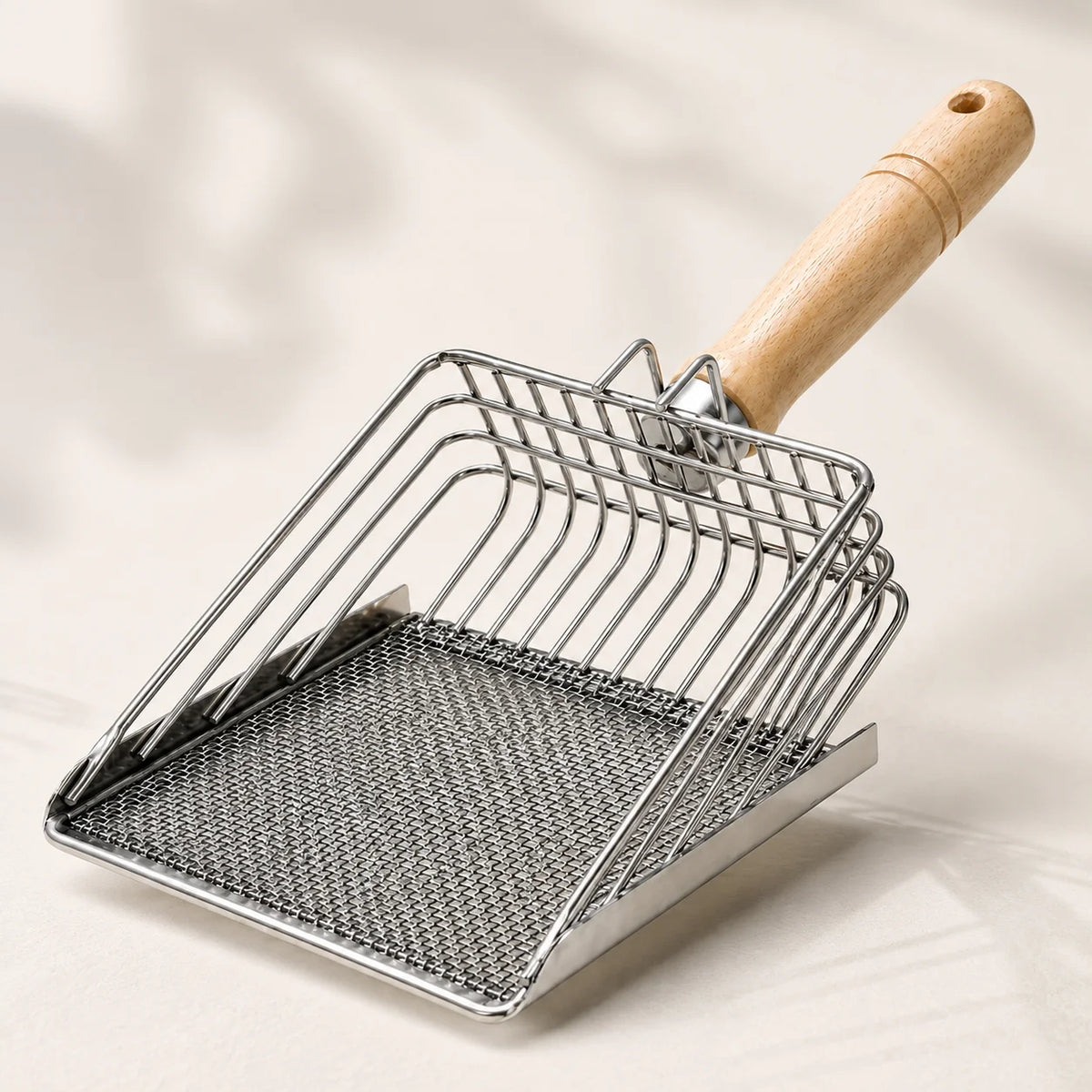 Stainless steel cat litter scoop with a wooden handle and fine mesh sifter
