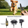 A dog wearing a training collar runs in a grassy field next to a handheld bidirectional charging device.