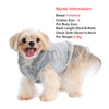 A light golden-colored dog wearing a gray fleece hoodie.