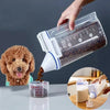 A hand pours rice-sized pet food from an airtight container into a measuring cup.
