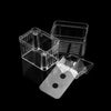 Clear acrylic fish breeding isolation boxes and a white tile with black dots