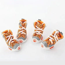 A set of four orange and gray Teddy Bear soft sole shoes for small dogs