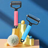 A pair of black and pink pet detangling combs displayed on a yellow wooden stand against a blue background.