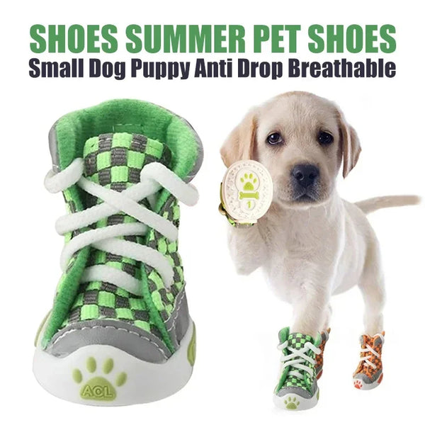 A light-colored puppy wearing green and gray breathable anti-slip dog shoes.