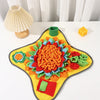 A colorful, textured snuffle mat for dogs with various fabric pieces arranged in a flower shape.