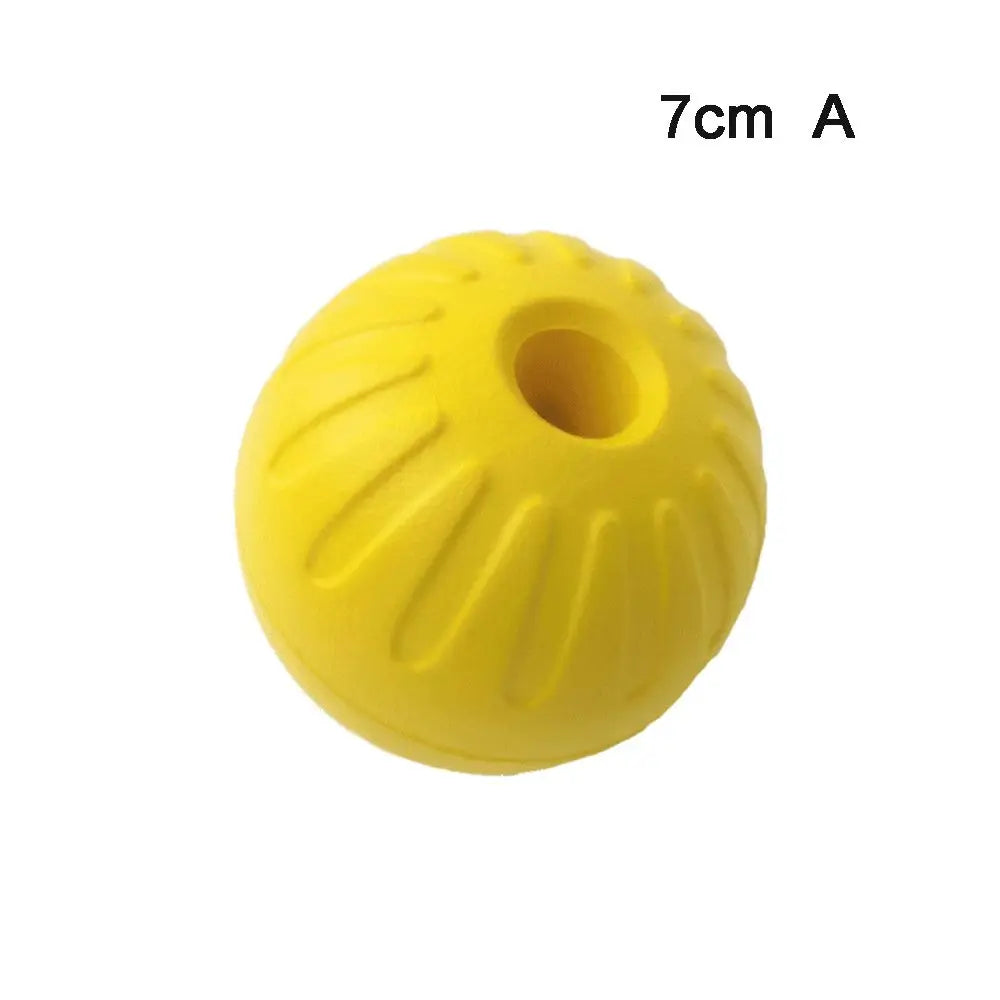 A yellow rubber fetch ball with a hole, labeled 7cm A.