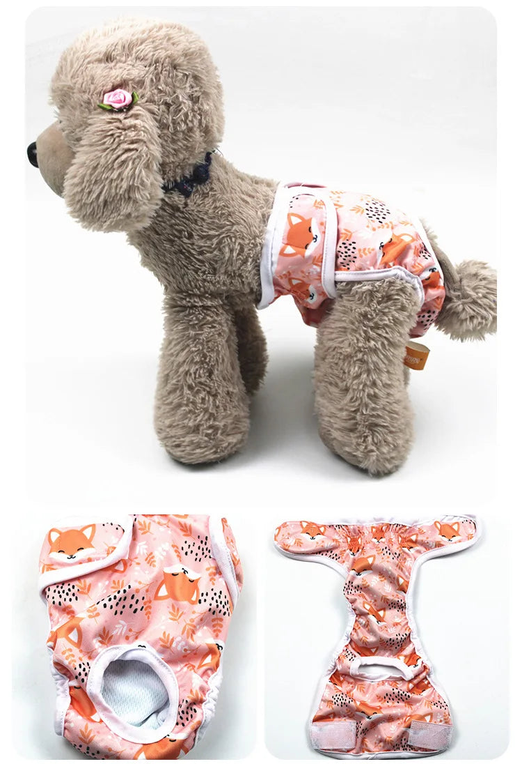 A fluffy dog wearing reusable female physiological panties in pink and orange floral patterns.