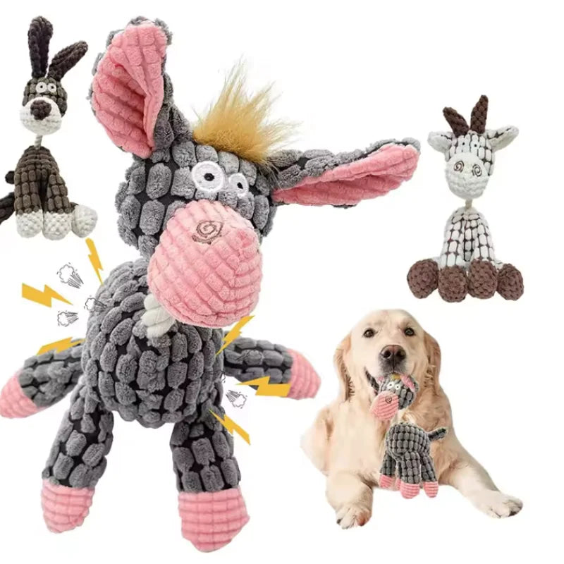 A plush squeaky donkey dog toy with pink and gray fur and ears, next to a golden retriever puppy.