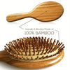 A wooden hair brush with bamboo bristles shown from above and below.