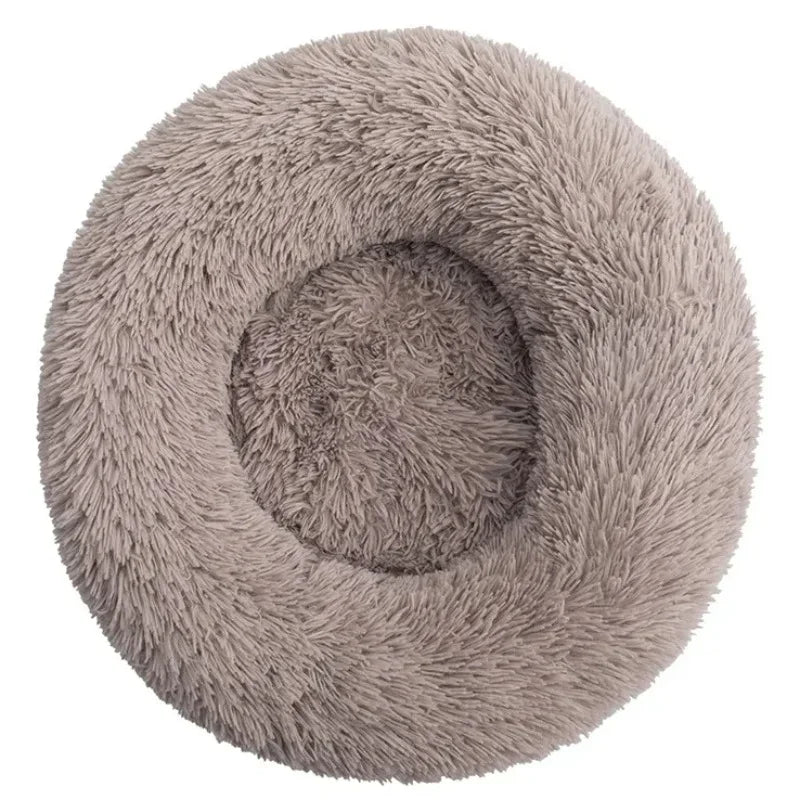 A round, fluffy, light gray pet bed for dogs and cats.