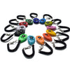 A collection of colorful adjustable pet training clickers on black wrist straps.