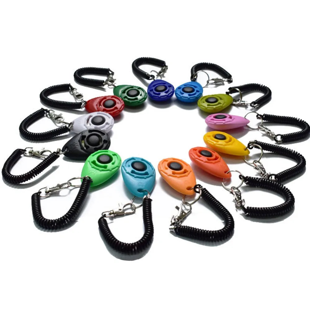 A collection of colorful adjustable pet training clickers on black wrist straps.