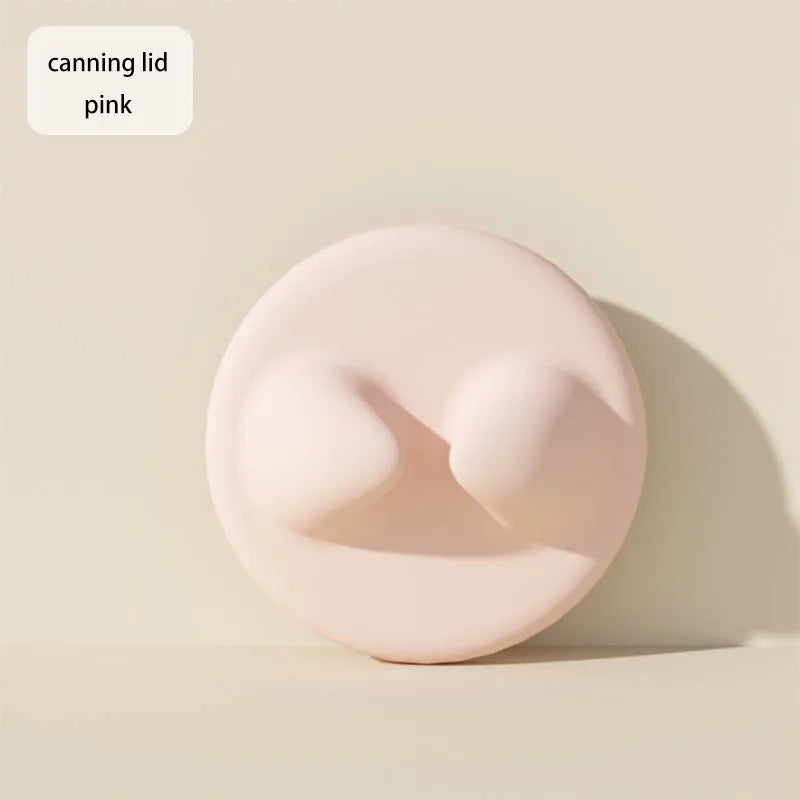 A pink silicone can lid product is shown against a light background.