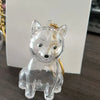 Figurine en résine d'un renard ou d'un canidé avec des oreilles dorées et une boucle pour porte-clés.