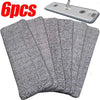 Six reusable gray microfiber mop pads and a cleaning tool are shown.
