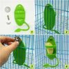A green bird shuttle feeding stand is shown being used by a hand inside a blue wire cage.