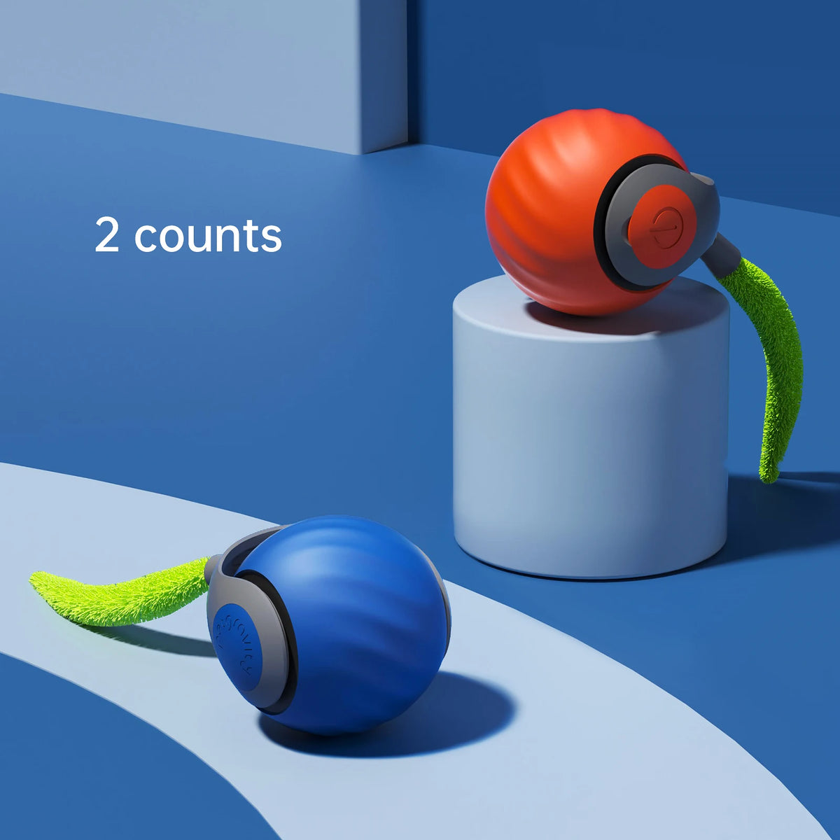 Two orange and blue interactive cat toy balls are shown on a light blue surface.