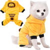 A fluffy white dog wearing a yellow fleece jumpsuit and hood with a crown detail.