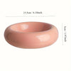 A round, pink ceramic donut cat bowl with a smooth finish and non-slip design.