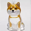 A transparent keychain featuring a cute fox-like dog head and body in golden yellow and white colors.