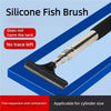 A silicone fish brush tool with a telescopic handle and scraper is shown against a blue background.