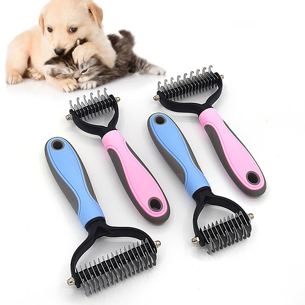 A set of pink and blue stainless steel pet deshedding combs lying on a white surface next to a puppy.