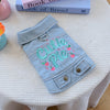 A light blue denim jacket for dogs embroidered with the text Cutie Pie