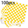 A stack of 100 sheets of yellow and white checkerboard oil-proof sandwich wrapping paper.