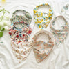 A collection of bohemian paisley triangle head scarves in floral patterns, including various colors and fabrics.