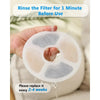 A hand is rinsing a white activated carbon filter disc under running water before use.
