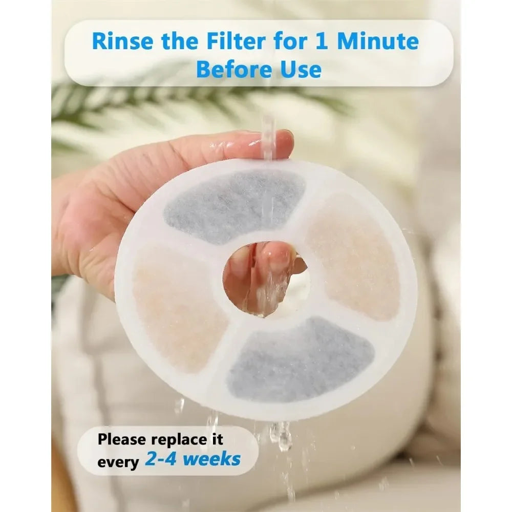 A hand is rinsing a white activated carbon filter disc under running water before use.