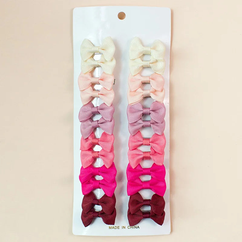 A set of colorful pet hair clips for dogs and cats in various shades of pink, beige, and purple.
