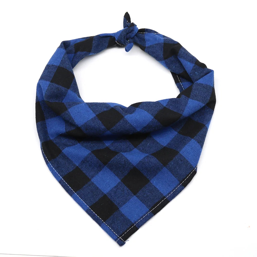 A navy blue and black plaid cotton dog bandana folded around the neck.