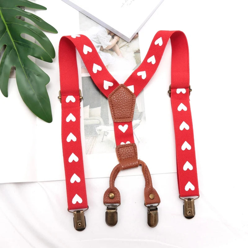 Red adjustable clip-on suspenders for kids with white heart pattern
