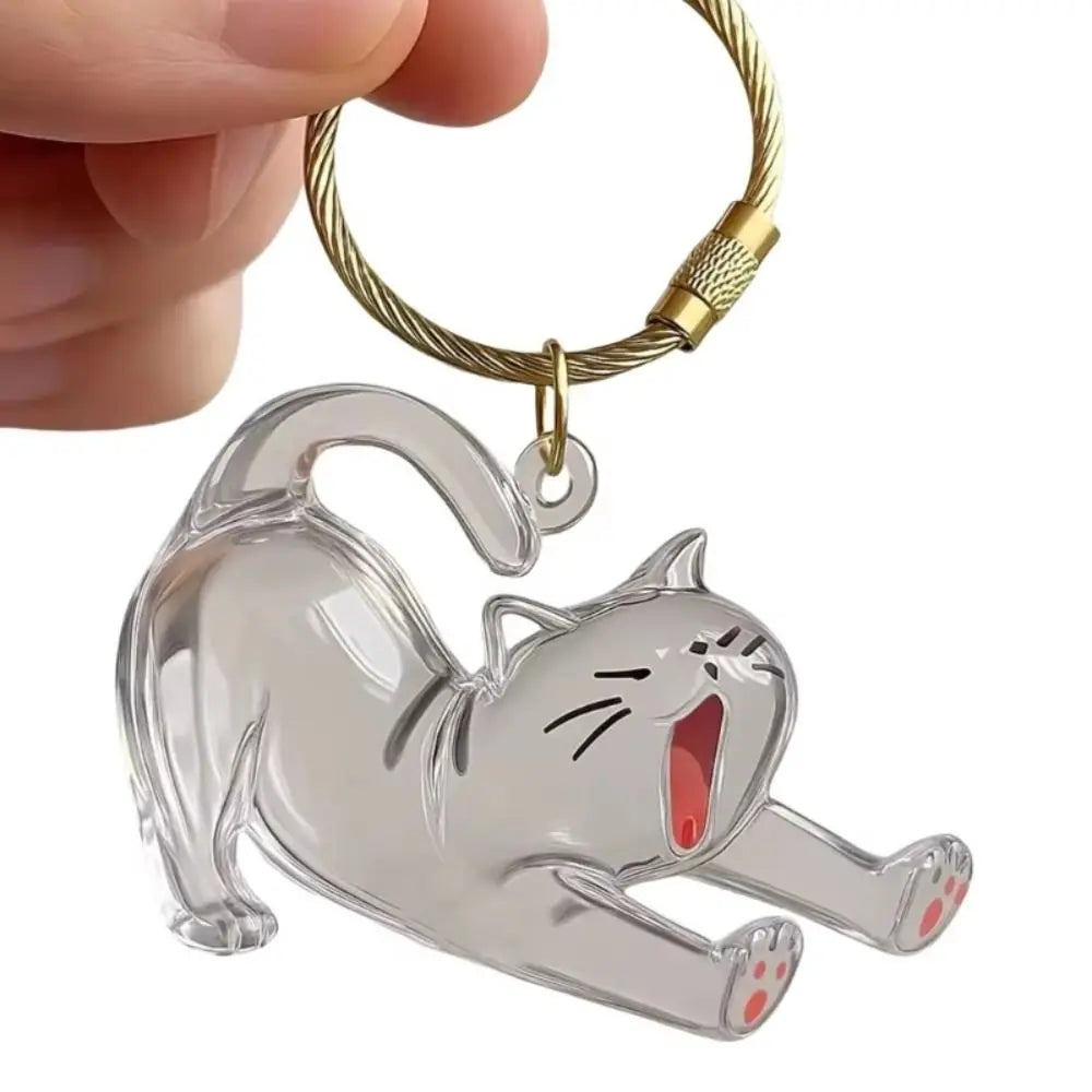 A clear acrylic cat silhouette charm attached to a gold-colored keyring.