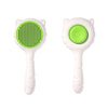 A white pet deshedding brush for cats and dogs with a bright green bristled head.